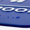 A close-up on the braille for the 9 x 6 ADA sign