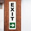 An exit sign on a wooden post