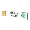 2” x 10” Corridor sign with white material color, black engraved text, logo, and gold holder on a white background with custom text saying “FITNESS ROOM”.