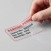 A window cling being peeled off a wall for a parking permit