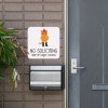 Cute orange cowboy cat no soliciting sign hung up next to the front door