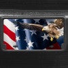 A close up of the American Flag and Eagle front license plate on a black car