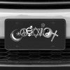 A close up of the Coexist front license plate on a white car