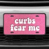A close up of the Curbs Fear Me front license plate on a white car