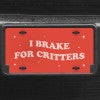A close up of the I Brake For Critters front license plate on a black car