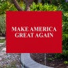 Maga yard sign next to pavement