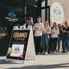 A grand opening A-frame sign placed outside of a new brewery
