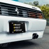 Front License Plate On White Car