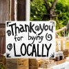 A custom made yard sign written in marker for a local vendor
