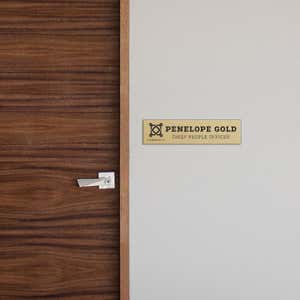 2 by 8 Plastic Sign By A Door As A Name Plate