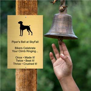 Custom Engraved Brass Sign Next to a Bell for Ringing After Completing a Bike Trail