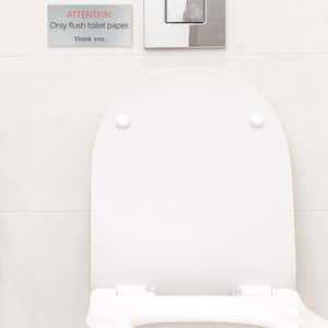 Silver Plastic Sign With Red and White Text Saying ATTENTION Only flush toilet paper