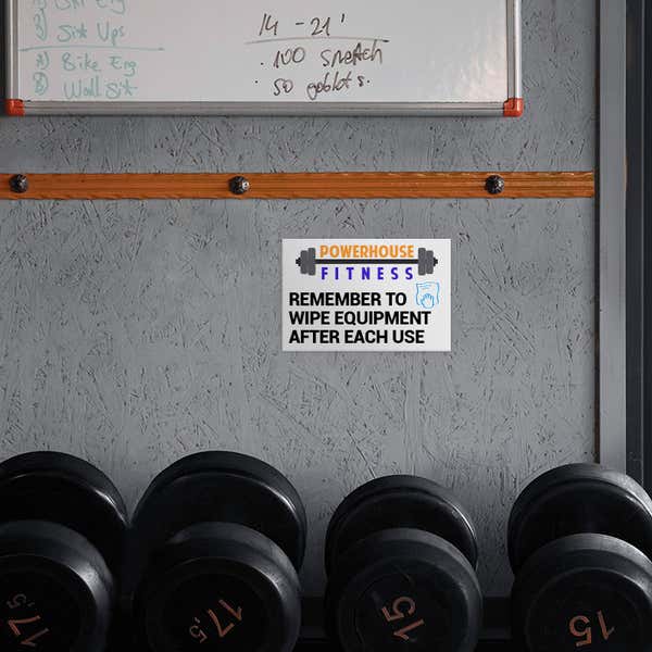 A Custom Plastic Sign for a Gym with a Colorful Logo and a Message to Gym Members