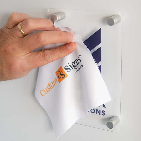 An Acrylic Sign Being Cleaned by a Microfiber Cleaning Cloth