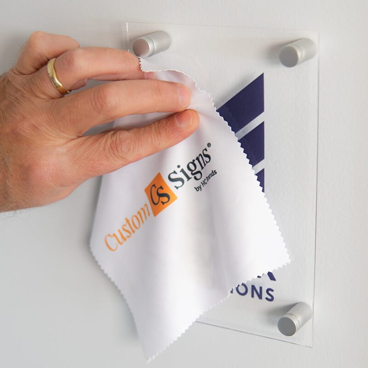 An Acrylic Sign Being Cleaned by a Microfiber Cleaning Cloth