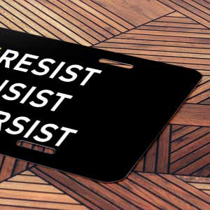 Front License Plate On Wooden Table