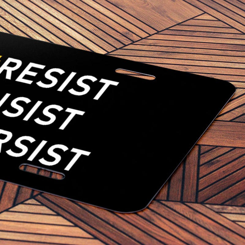 Front License Plate On Wooden Table