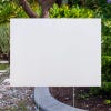 Blank yard sign shown by pavement
