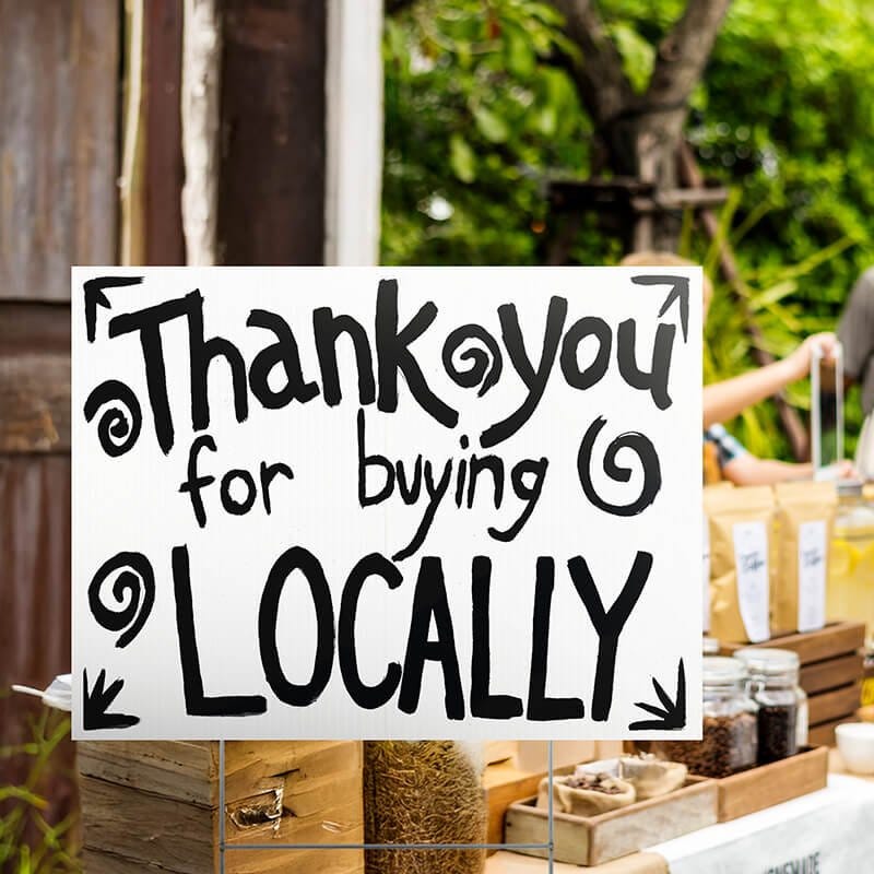 A custom made yard sign written in marker for a local vendor