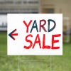 A custom made yard sign written in marker for a yard sale