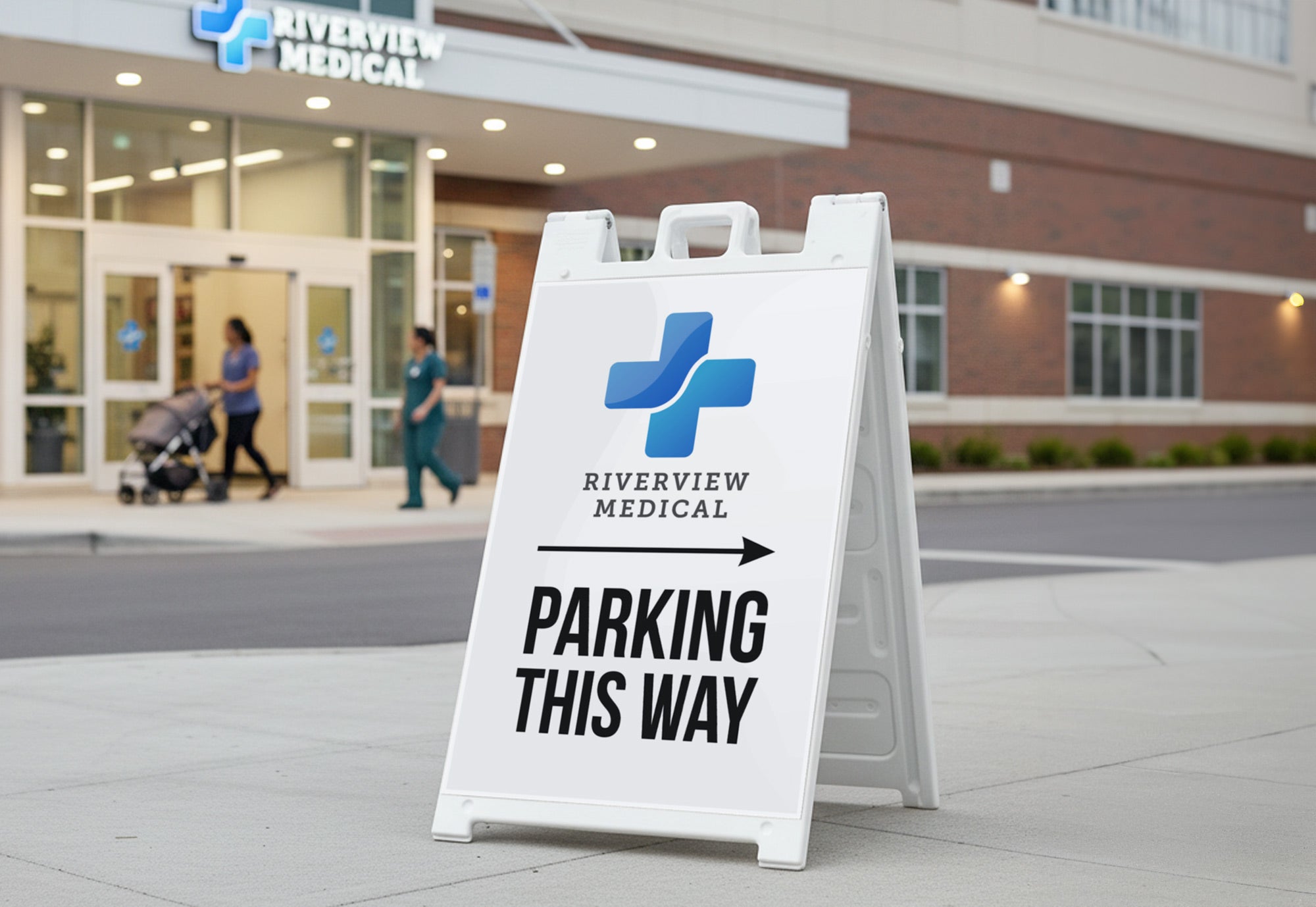 A sandwich board sign by a medical center pointing towards the facility's parking area